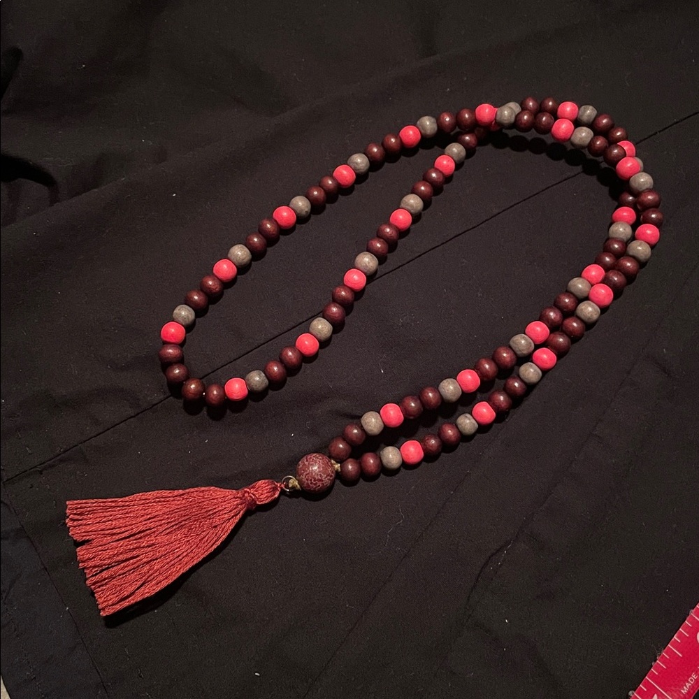 Hand assembled beaded necklace burnt amber cotton tassel